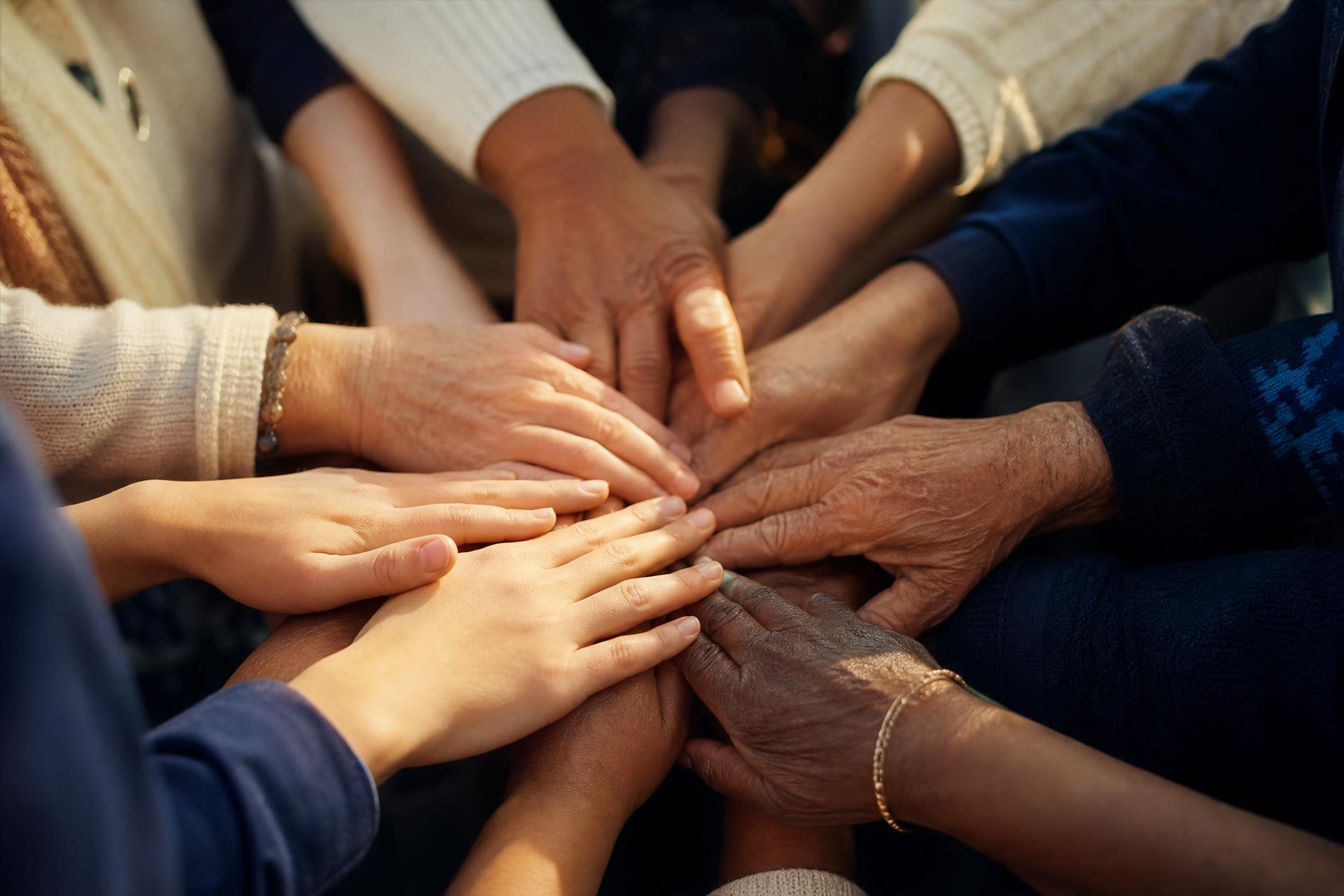 Diverse hands joined together in community